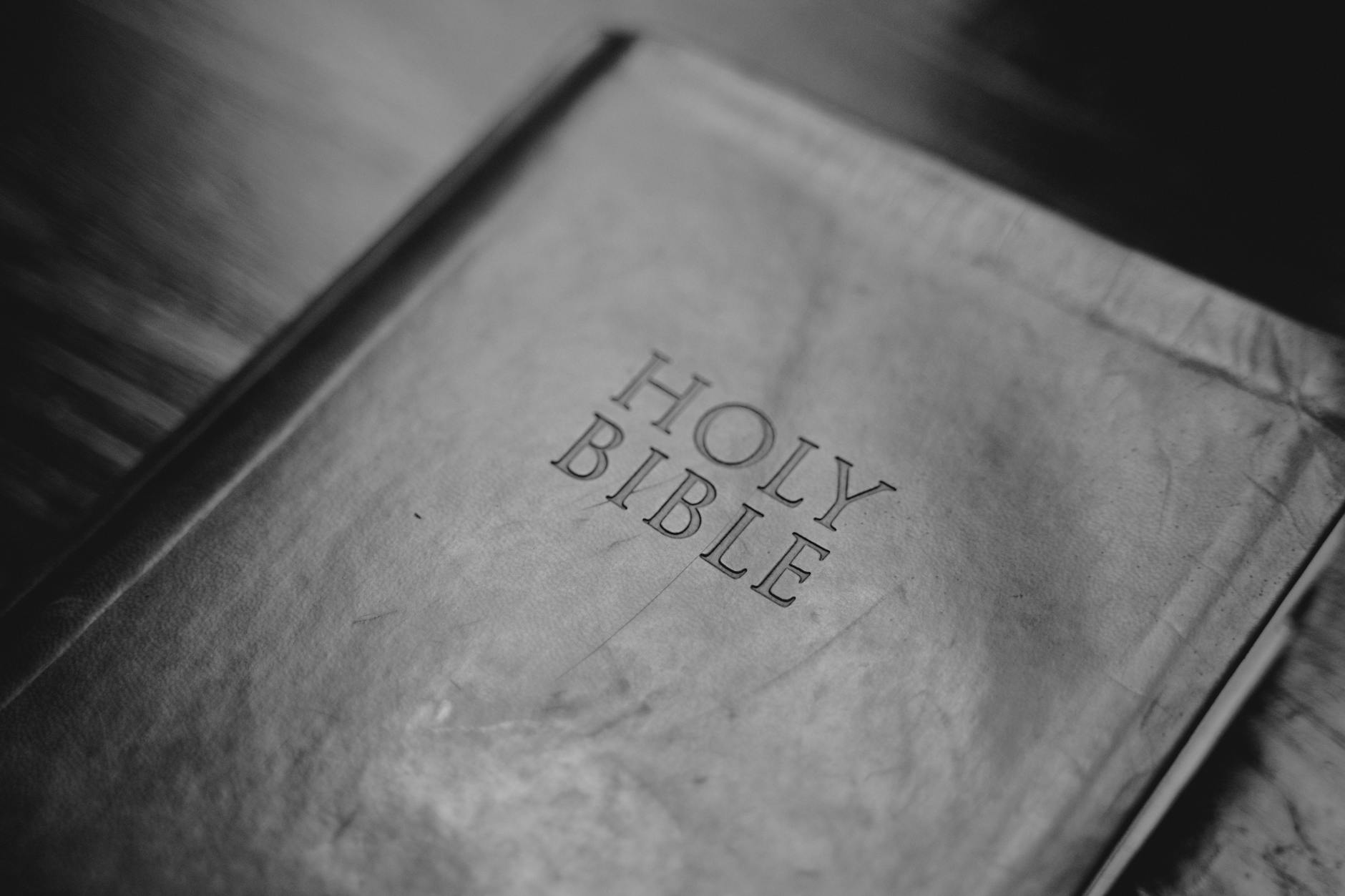 a grayscale of the holy bible